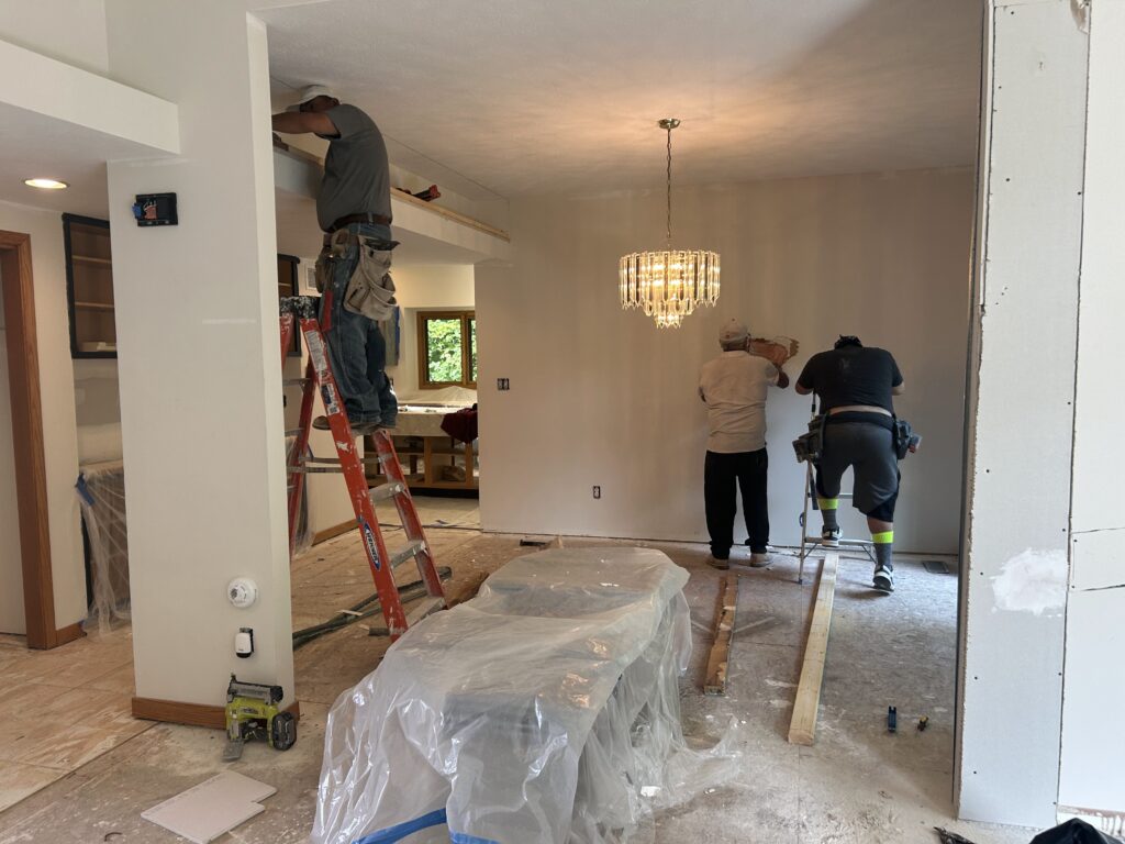 Mister Painter Group crew installing soffit trim during a kitchen and dining room remodel