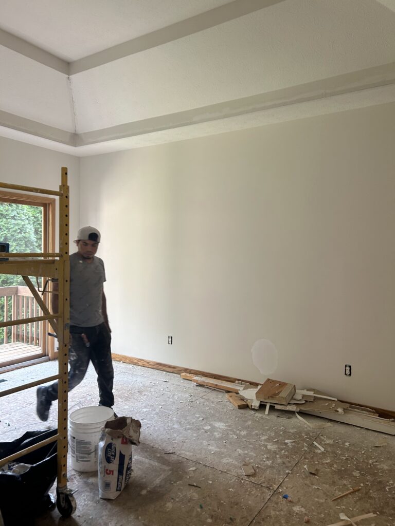 Dining room freshly painted with a tray ceiling next to the remodeled kitchen
