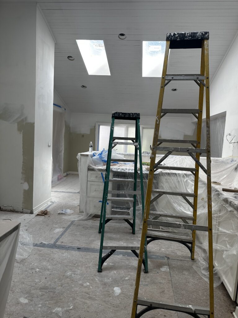 Vaulted kitchen ceiling with skylights freshly painted white by Mister Painter Group